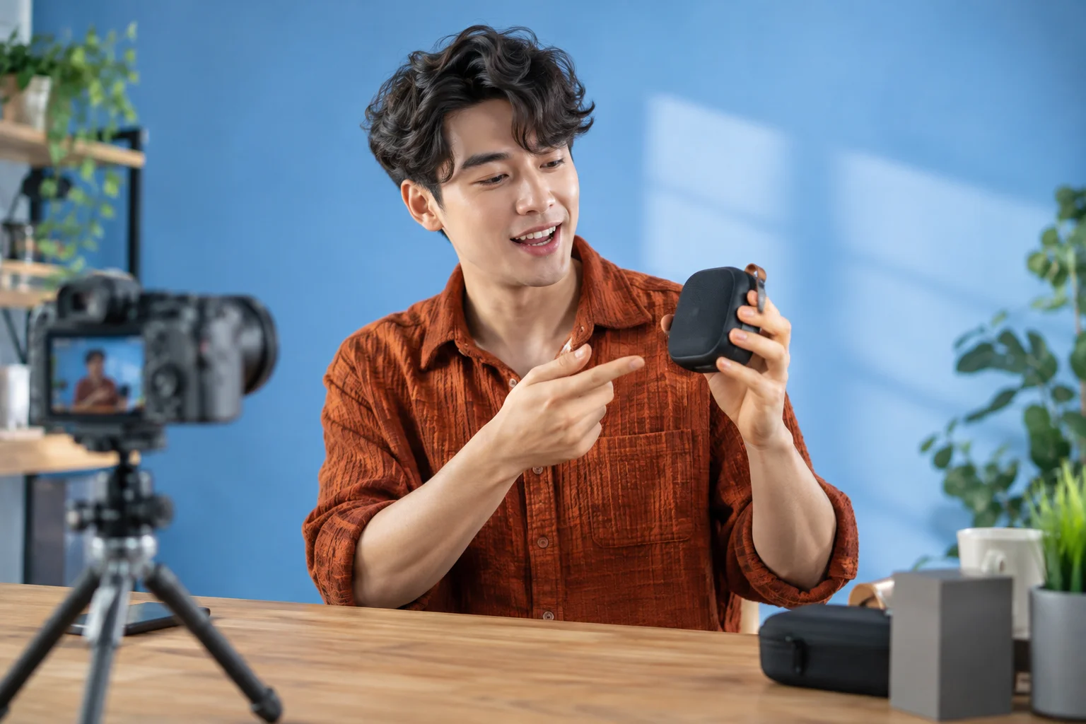 A tech creator enjoying a hands-on demonstration in a bright blue studio